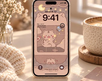 May include: A smartphone with a clear protective case displaying a digital wallpaper featuring a cartoon tiger character, a crescent moon, stars, and a planet. The screen shows the time 9:41, the date Mon 6, and weather information in a soft beige color palette.