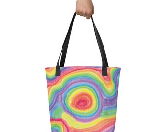 May include: A rainbow-colored tote bag with a watercolor design of swirling circles and lines. The bag has black handles.
