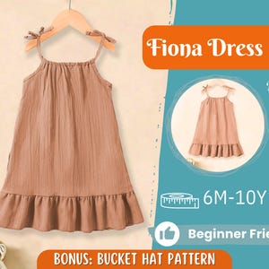 Pode incluir: Um vestido marrom sem mangas com uma bainha de babados e alças finas. O vestido é rotulado como "Fiona Dress" e está disponível nos tamanhos 6M-10Y. O texto "Beginner Friendly" também está incluído na imagem.