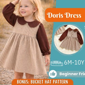 May include: A young girl wearing a brown and tan checkered dress with a brown collar and sleeves. The dress is paired with a matching bucket hat pattern. The image includes the text "Doris Dress", "Back View", "6M-10Y", and "Beginner Friendly".