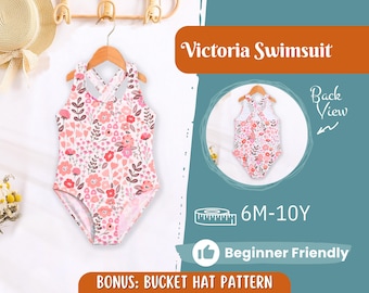 May include: A floral print Victoria swimsuit for children, displayed on a wooden hanger. The swimsuit features a white background with pink and red flowers and green leaves. The image also includes a back view of the swimsuit, and text that reads "6M-10Y" and "Beginner Friendly."