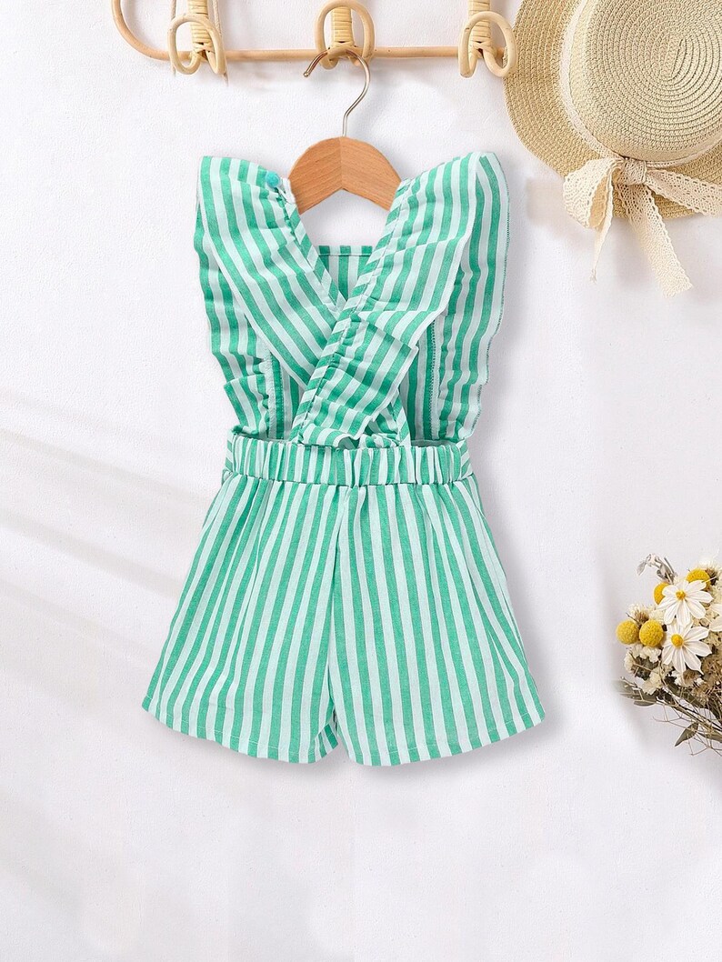 May include: A green and white striped sleeveless romper with a ruffled neckline and a criss-cross back.