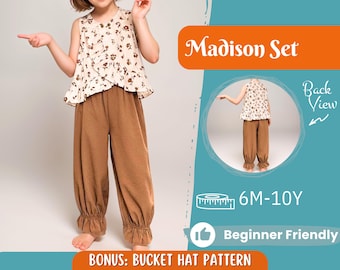 May include: A brown and white floral print sleeveless top and brown cuffed pants sewing pattern for children. The pattern includes a bucket hat pattern and is beginner friendly. The pattern is for sizes 6 months to 10 years. The pattern is called "Madison Set".