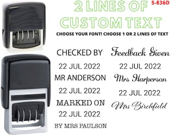 May include: A black self-inking stamp with a clear rectangular impression area. The stamp is labeled "2 LINES OF CUSTOM TEXT" and "S-836D". The text "CHOOSE YOUR FONT! CHOOSE 1 OR 2 LINES OF TEXT" is also visible. The stamp is shown with an example of a custom text imprint that reads "CHECKED BY Feedback Given", "22 JUL 2022", "MR ANDERSON Mrs Harperson", "22 JUL 2022", "MARKED ON Mrs Birchfield", "22 JUL 2022", and "BY MRS PAULSON".