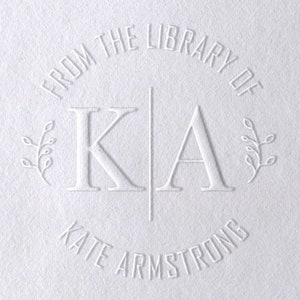 May include: White embossed stamp with the text "From the Library of K.A. Kate Armstrong" and two small leafy branches on either side of the initials.