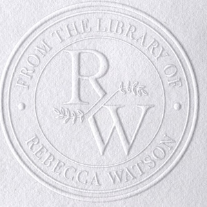 May include: A white embossed circular seal. The text "FROM THE LIBRARY OF REBECCA WATSON" is around the edge. The centre has intertwined "R" and "W" letters, with a sprig of leaves. The design is on a textured white surface.