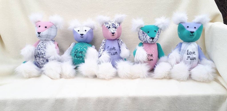 May include: Five handmade patchwork teddy bears with white fur. Each bear has a different color combination and features the text "Love Mum" or "Love, Mum".