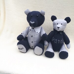 May include: Two handmade plush teddy bears, one black and one gray, with embroidered details. The black bear has a gray shirt and the text "Alan" on its foot. The gray bear has the text "Grandy" on its chest.