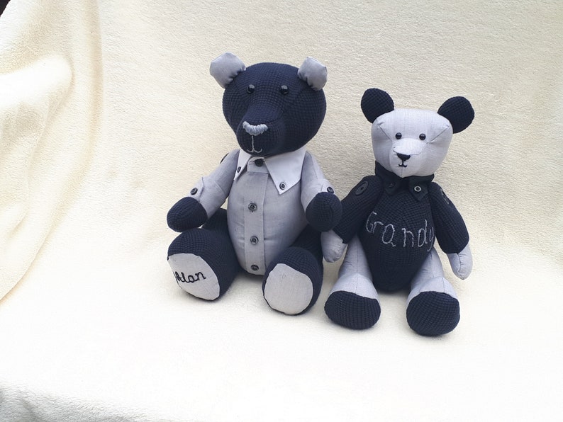 May include: Two handmade plush teddy bears, one black and one gray, with embroidered details. The black bear has a gray shirt and the text "Alan" on its foot. The gray bear has the text "Grandy" on its chest.