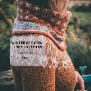 May include: A knitted cowl in shades of brown, orange, and white, with a snowflake design. The cowl has a high neck and is labeled "Winter Sky Cowl Knitting Pattern" with the language listed as English.