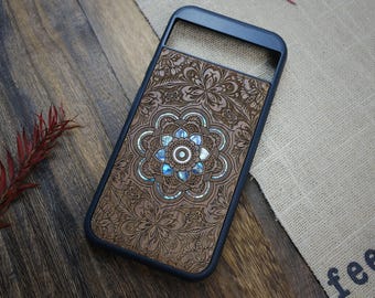 May include: A wooden phone case with a blue and white mandala design. The case is made of wood and has a black border.