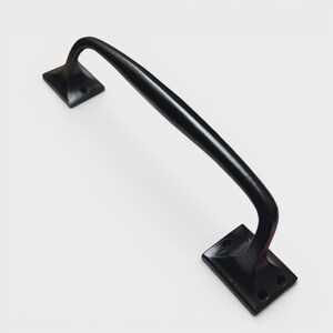 May include: A black, curved door pull with a rectangular base at each end. The handle is a smooth, arched bar. The bases have a square shape with rounded corners and screw holes. The hardware is made of metal.