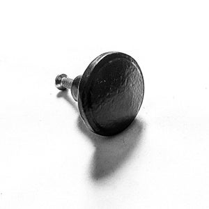 May include: Black metal knob with a round, slightly textured surface and a screw.