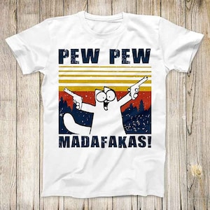 May include: White t-shirt featuring a retro-style graphic of a cat holding two guns and the text "PEW PEW MADAFAKAS!"