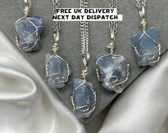 May include: Five silver necklaces with blue crystal pendants. Each pendant is wrapped in silver wire. The necklaces are displayed on a white surface. FREE UK DELIVERY NEXT DAY DISPATCH.
