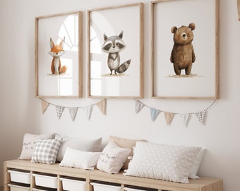 May include: Three framed watercolour prints of woodland animals: a fox, a raccoon, and a bear. The prints are displayed above a wooden storage unit with white bins. Decorative pillows and a banner with triangle flags decorate the room.