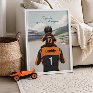 May include: A framed print featuring an illustration of a person wearing a black and orange racing suit with the number 1 and the word Daddy on the back, carrying a child in a racing suit with the number 10 and the name Oliver. Text reads: Daddy. you're my champion.