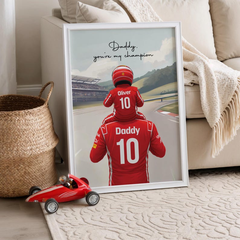 May include: A framed wall art print featuring a child wearing a red racing suit and helmet sitting on the shoulders of an adult in a matching red racing suit. Both wear the number 10. The text reads: Daddy, you're my champion and Oliver.