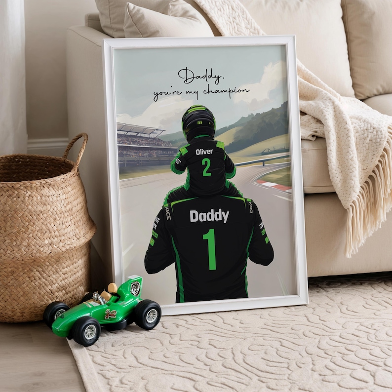 May include: A framed print featuring a digital illustration of a person wearing a black and green racing suit with the number 1 and the word Daddy, carrying a child in a racing suit with the number 2 and the name Oliver. Text reads: Daddy. you're my champion.