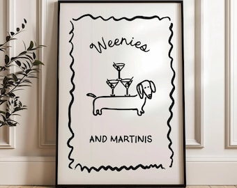 May include: Black framed art print featuring a whimsical illustration of a dachshund with martini glasses stacked on its back. The text reads "Weenies AND MARTINIS" in a playful font. The artwork is set against a white background.