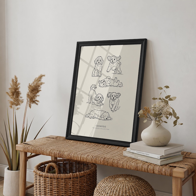 May include: A framed wall art print featuring six black line-art illustrations of Cavapoo dogs in various poses on a light beige background. The text "CAVAPOO" and "THE BREED COLLECTION" is printed in small black letters at the bottom center.