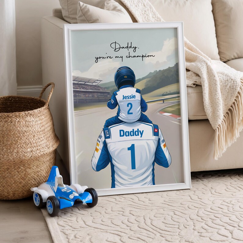 May include: A framed wall art print featuring a cartoon illustration of a person in a white and blue racing suit labeled Daddy with the number 1, carrying a child in a matching suit labeled Jessie with the number 2, with the text Daddy, you're my champion.