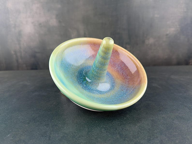 Handmade ceramic ring holder featuring flowing glaze and natural color variation, pottery jewelry holder with glossy surface and unique finish. Pictured here Ocean Sunset glaze option.