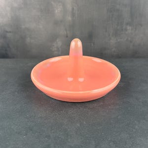 Handmade ceramic ring holder featuring flowing glaze and natural color variation, pottery jewelry holder with glossy surface and unique finish. Pictured here is red/pink gloss option.