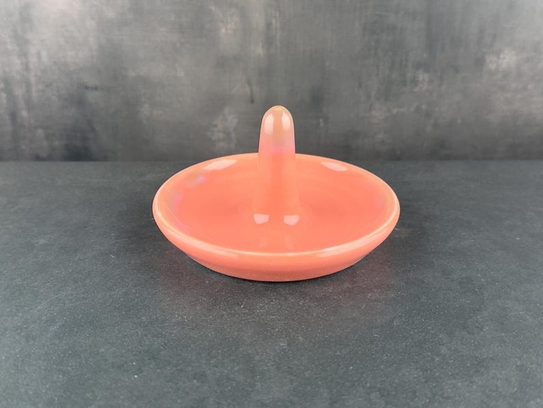 Handmade ceramic ring holder featuring flowing glaze and natural color variation, pottery jewelry holder with glossy surface and unique finish. Pictured here is red/pink gloss option.
