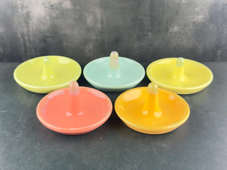 Handmade ceramic ring holder featuring flowing glaze and natural color variation, pottery jewelry holder with glossy surface and unique finish. Pictured here are my bright color options, red/pink, orange, chartreuse, sea glass blue and lemon yellow gloss options.