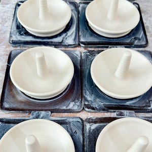 Handmade ceramic ring holder featuring flowing glaze and natural color variation, pottery jewelry holder with glossy surface and unique finish.