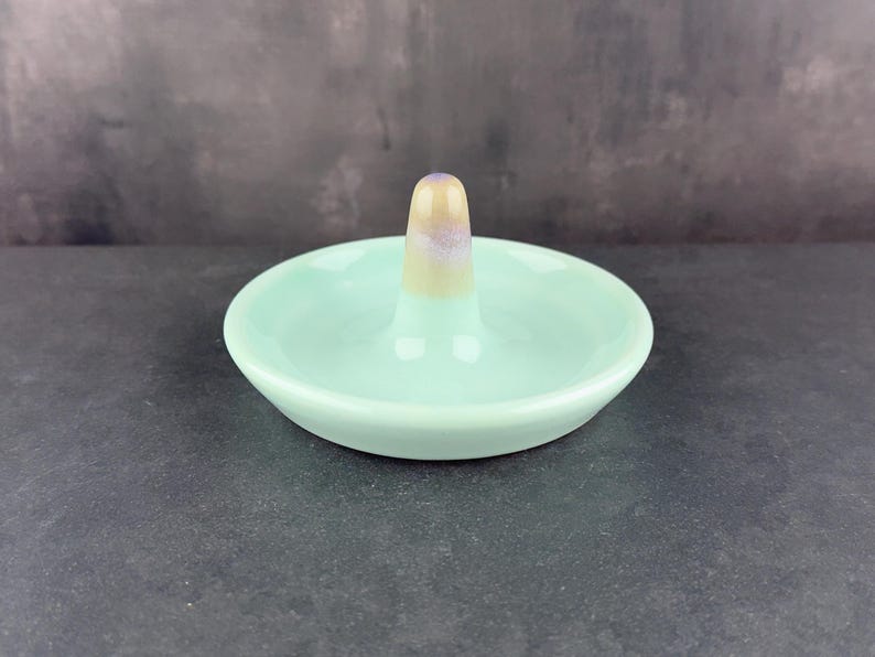 Handmade ceramic ring holder featuring flowing glaze and natural color variation, pottery jewelry holder with glossy surface and unique finish. Pictured here is sea glass gloss option.