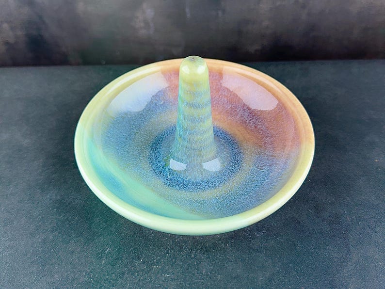 Handmade ceramic ring holder featuring flowing glaze and natural color variation, pottery jewelry holder with glossy surface and unique finish. Pictured here Ocean Sunset glaze option.