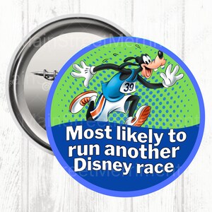 May include: A circular badge featuring Goofy in running attire, with the number 39. The badge has the text "Most likely to run another Disney race" in white on a blue background, with a green dotted background.