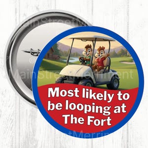May include: A circular badge with a blue border and a red centre. It features a cartoon image of two chipmunks in a golf cart. The text "Most likely to be looping at The Fort" is displayed in white.
