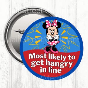 May include: A circular badge with a cartoon mouse illustration, wearing a pink polka dot bow and dress, with an angry expression. The text on the badge reads "Most likely to get hangry in line."