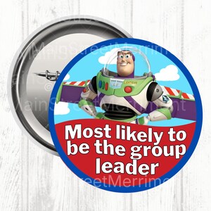 May include: A circular pinback button featuring Buzz Lightyear from Toy Story against a blue sky with white clouds. The text "Most likely to be the group leader" is printed in white on a red background at the bottom of the button design.