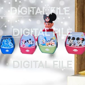May include: A garland of four colorful, egg-shaped lanterns featuring Disney characters. The lanterns are blue, pink, and green, with images of Mickey and Minnie Mouse, Donald Duck, and other characters. An elf wearing a Mickey Mouse hat is attached to the garland.