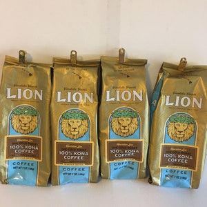 May include: Four gold-colored coffee bags with the Lion logo and text. Each bag features a lion's head with a laurel wreath, the words "24K Gold Roast 100% Kona Coffee", and "Whole Bean". Each bag contains 7 oz (198g) of coffee.