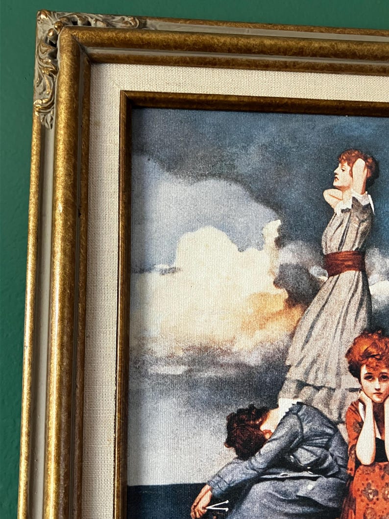 May include: A framed vintage print of a painting depicting five women standing on a cloud in a sky with a dramatic, stormy background. The women are dressed in clothing from the early 1900s. The print is framed in a gold-colored frame.