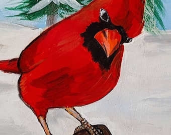 Puede incluir: Un pájaro cardenal rojo con ojos negros y un pico negro posado en una rama marrón. El pájaro está en una escena de invierno nevada.