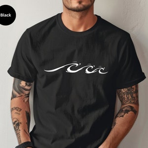 May include: Black crew neck t-shirt with a white wave design across the chest. The shirt is made of a soft material and has short sleeves. The word "Black" is in a black circle in the upper left corner.