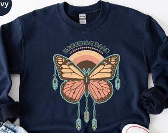 May include: Navy blue sweatshirt with a butterfly graphic and the text "Bohemian Babe". The butterfly has orange and pink wings with a brown body. The design includes a rainbow and hanging feathers.
