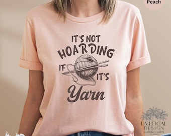 May include: A pink t-shirt with the text "It's not hoarding if it's yarn" and a drawing of a ball of yarn with knitting needles.
