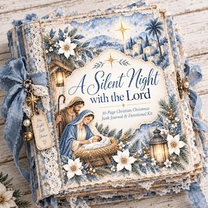 May include: A square junk journal titled A Silent Night with the Lord, featuring a nativity scene illustration, blue and white floral patterns, lace trim, and a blue ribbon binding. A metal charm tag reads His Light Still Shines with a small bell.