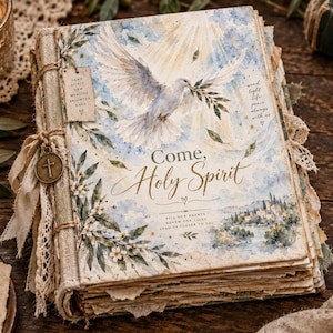 May include: A hardcover book titled Come, Holy Spirit featuring a watercolor illustration of a white dove, olive branches, and a landscape. The cover includes text, a small hanging tag, and a metal cross charm attached to the spine with lace.