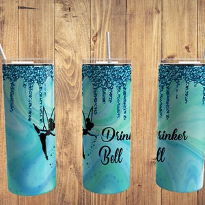 May include: Three stainless steel tumblers with a blue and green marble design and a glitter top. The tumblers feature a silhouette of Tinkerbell with a quote that says "Drink Up Bell".