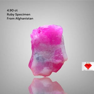 May include: A vibrant pink ruby specimen from Afghanistan, weighing 4.90 ct. The gemstone has a rough, crystalline structure with white and pink hues. The image includes the text "4.90 ct Ruby Specimen From Afghanistan".