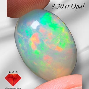 May include: A 8.30 ct oval-shaped opal gemstone with a white base and flashes of green, orange, and red.