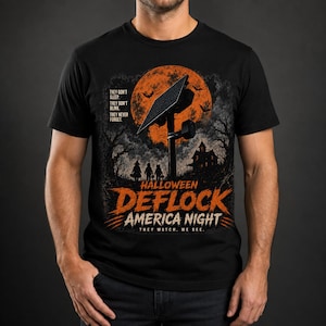 May include: A black t-shirt featuring a graphic of a solar panel against a large orange moon, silhouettes of three children, a house, and bats. Text reads: THEY DON'T SLEEP. THEY DON'T BLINK. THEY NEVER FORGET. HALLOWEEN DEFLOCK AMERICA NIGHT. THEY WATCH. WE SEE.